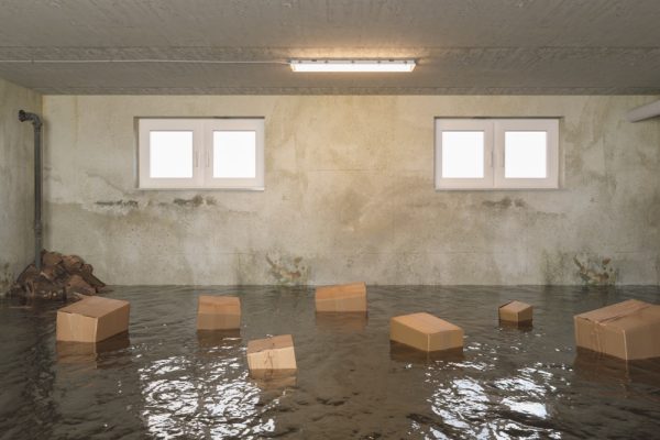 flooded basement of the house with wet Cardboard boxes in the water